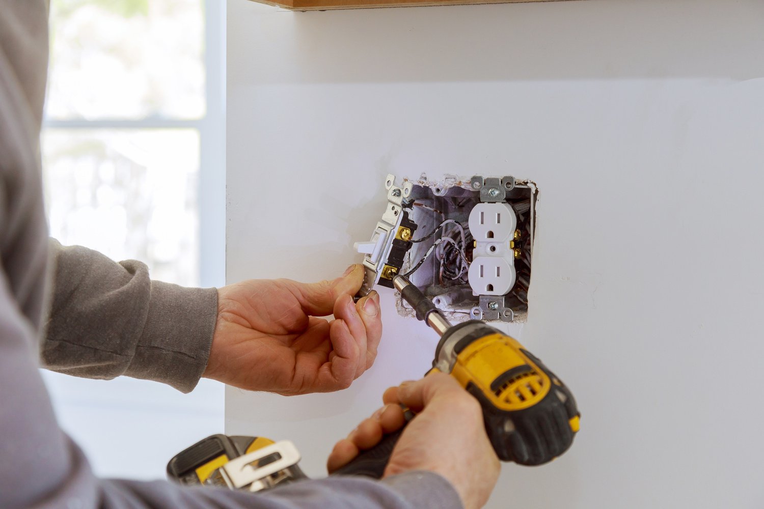 Worker Installing Electrical Outlets